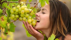 Woman grapes eating closed eyes