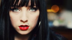 Woman green eyes bangs black hair