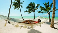 Woman hammock palm trees sunglasses bikini