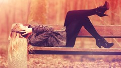 Woman headphones bench lying down