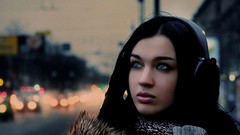 Woman headphones faces blue eyes brunettes black hair citylife