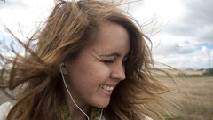 Woman headphones outdoors smiling closed eyes brunettes