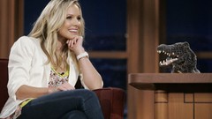 Woman jeans Kristen Bell Actress watches smiling puppets Craig 