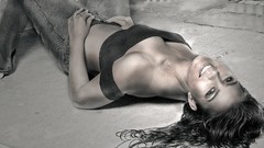 Woman jeans monochrome smiling lying down greyscale selective 
