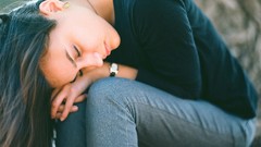 Woman jeans sitting closed eyes