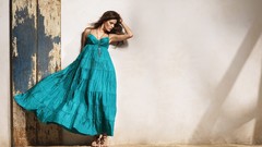 Woman looking down brunettes blue dress