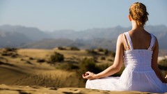 Woman meditation outdoors white dress