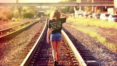 Woman models railroad tracks denim shorts