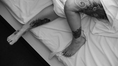 Woman monochrome legs tattoos