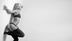 Woman monochrome stockings lingerie arms raised