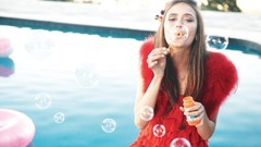 Woman Nina Dobrev models blowing bubbles