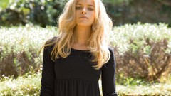 Woman outdoors blondes green eyes black shirt