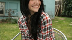Woman outdoors smiling freckles black hair