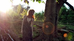 Woman outdoors sunlight black dress redheads