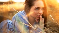 Woman outdoors sunlight blue eyes brunettes lying down