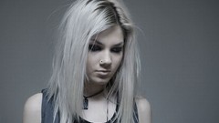 Woman pale blondes grey background pierced nose