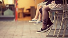 Woman photographer legs tattoos