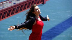 Woman red dress outdoors golden gate bridge arms raised