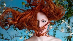 Woman redheads hair in face