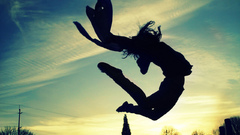 Woman silhouettes jumping arms