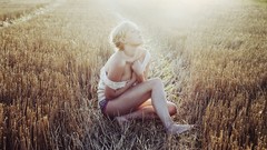 Woman sitting fields blondes sunlight closed eyes short hair