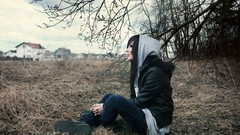 Woman sitting hoodies outdoors