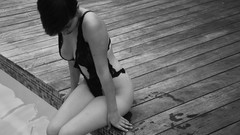 Woman sitting monochrome short hair cleavage bodysuits swimming 