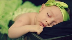 Woman sleeping babies green dress