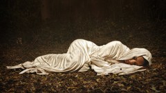 Woman sleeping fallen leaves