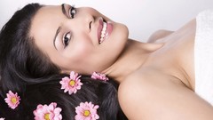 Woman smiling brunettes lying down flower in hair spa
