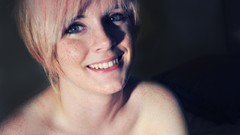 Woman smiling short hair freckles