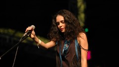 Woman stage microphones brunettes singers curly hair Yasemin 