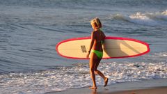 Woman surfing Beaches