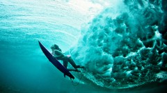 Woman surfing underwater Oceans waves bikini