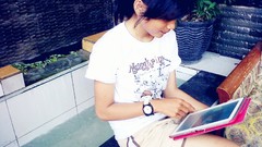 Woman Tablets sitting short hair black hair dyahayu