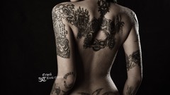 Woman tattoos back view artistic body painting