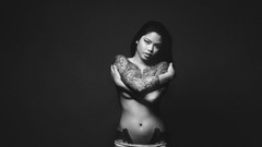 Woman tattoos grayscale strategic covering topless