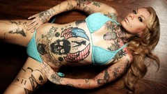 Woman tattoos piercings bikini spread legs facial piercings