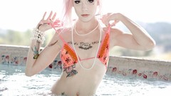 Woman tattoos pink hair swimming pools