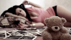 Woman teddy bears cleavage laying down