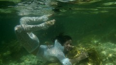 Woman underwater wet swimming white dress models black hair 