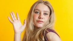 Woman yellow background faces blondes long hair gray eyes 