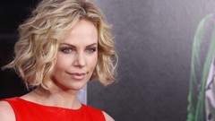 Woman young red dress charlize theron red carpet curly hair