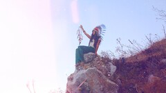 Women feathers women outdoors rock sitting model