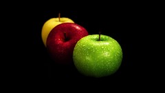 Yellow red Green apples black background wet fruits