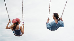 Young couple on swings