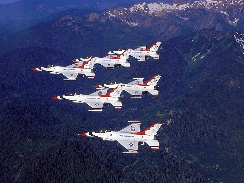 Thunderbirds fly over mountains