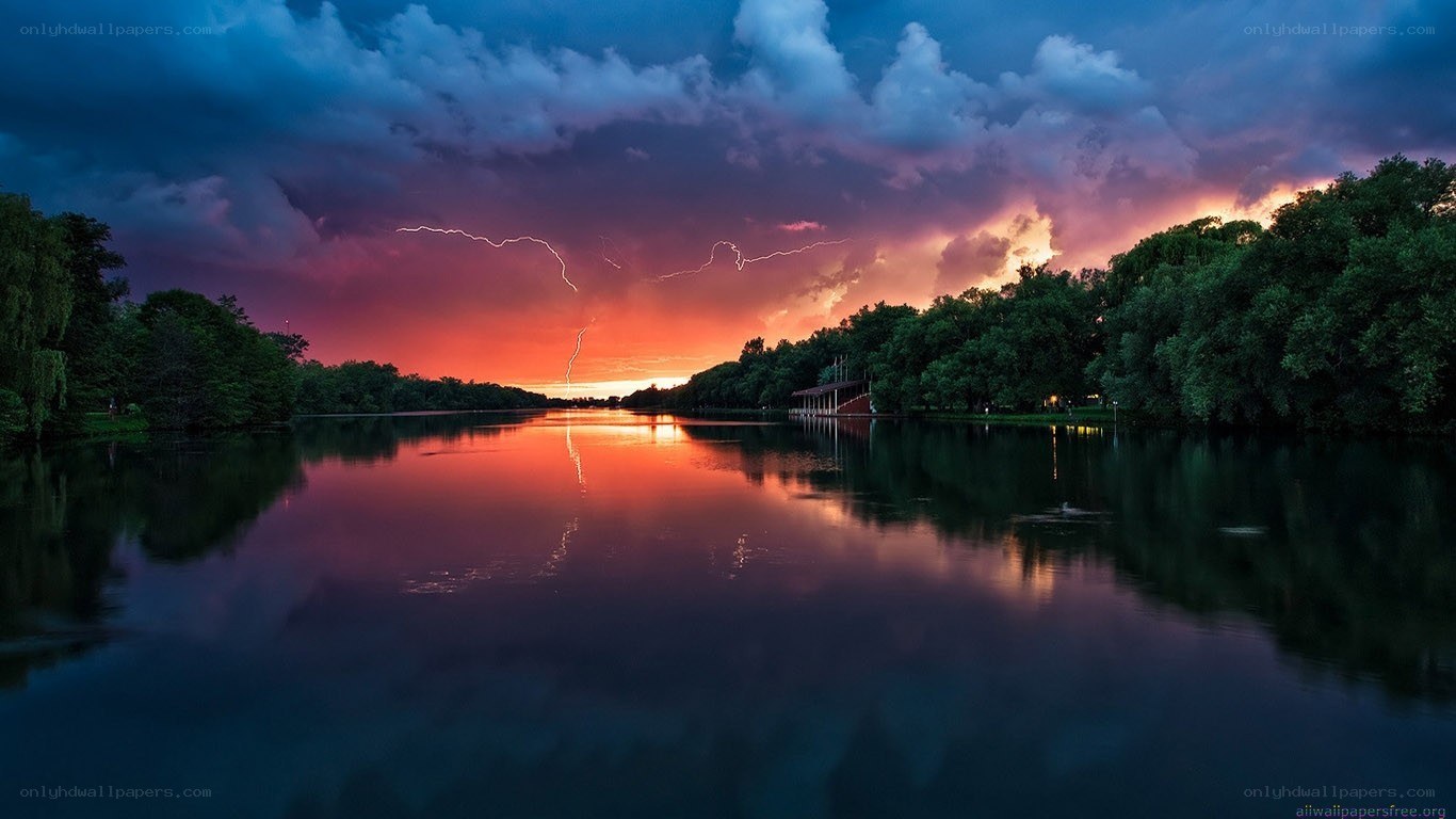 Thunderstorm over a lake at sunset