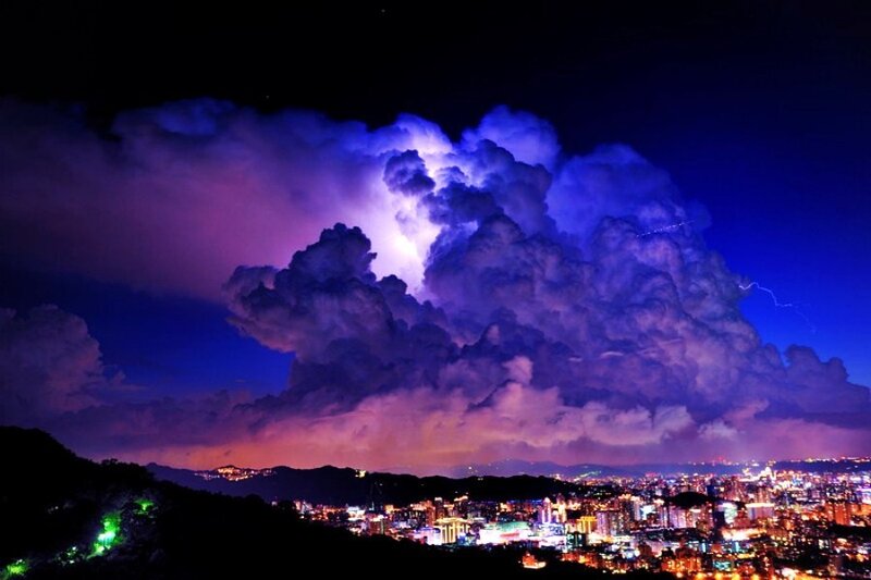 Thunderstorm over city at night
