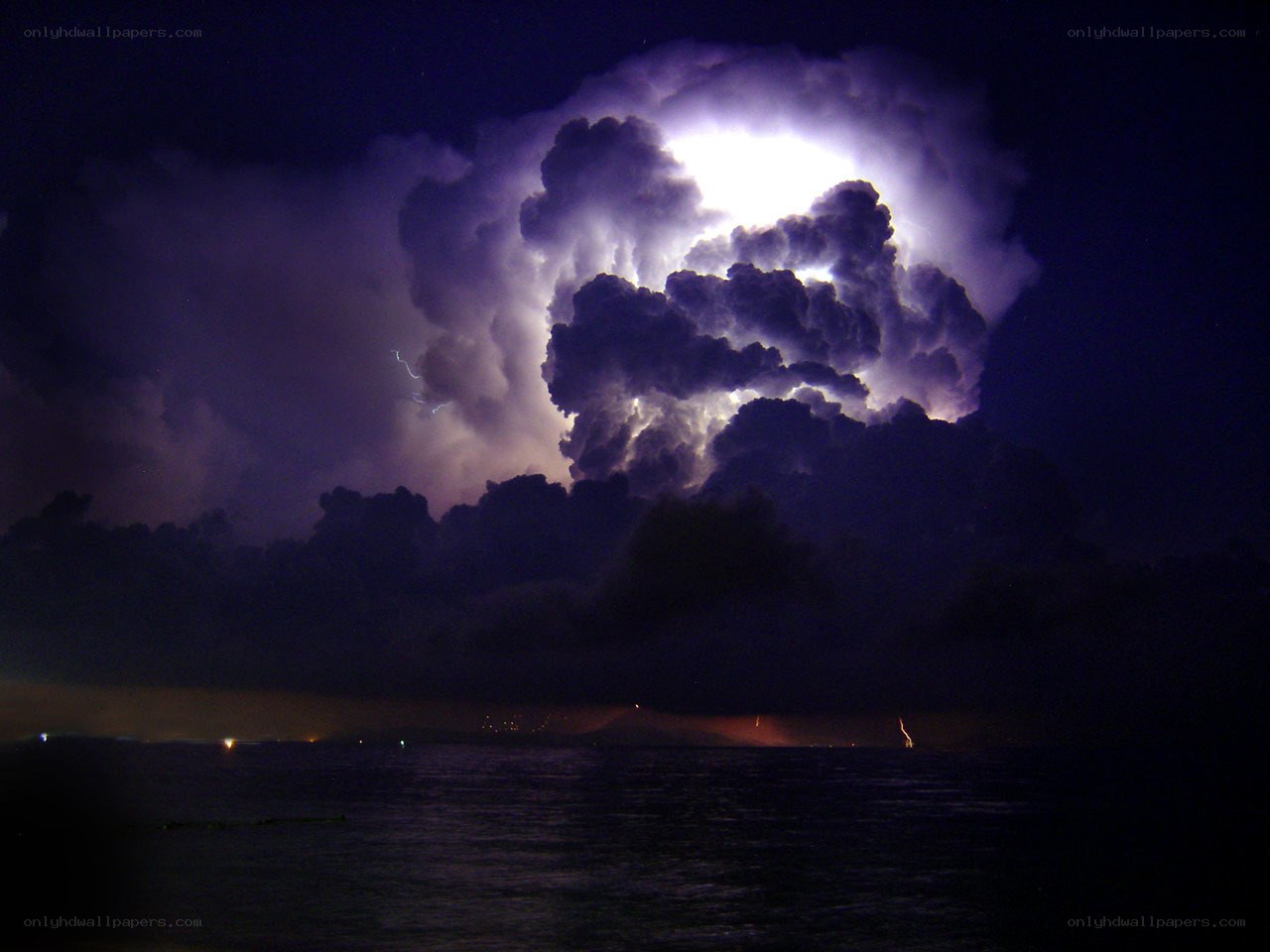 Thunderstorm over the ocean at night